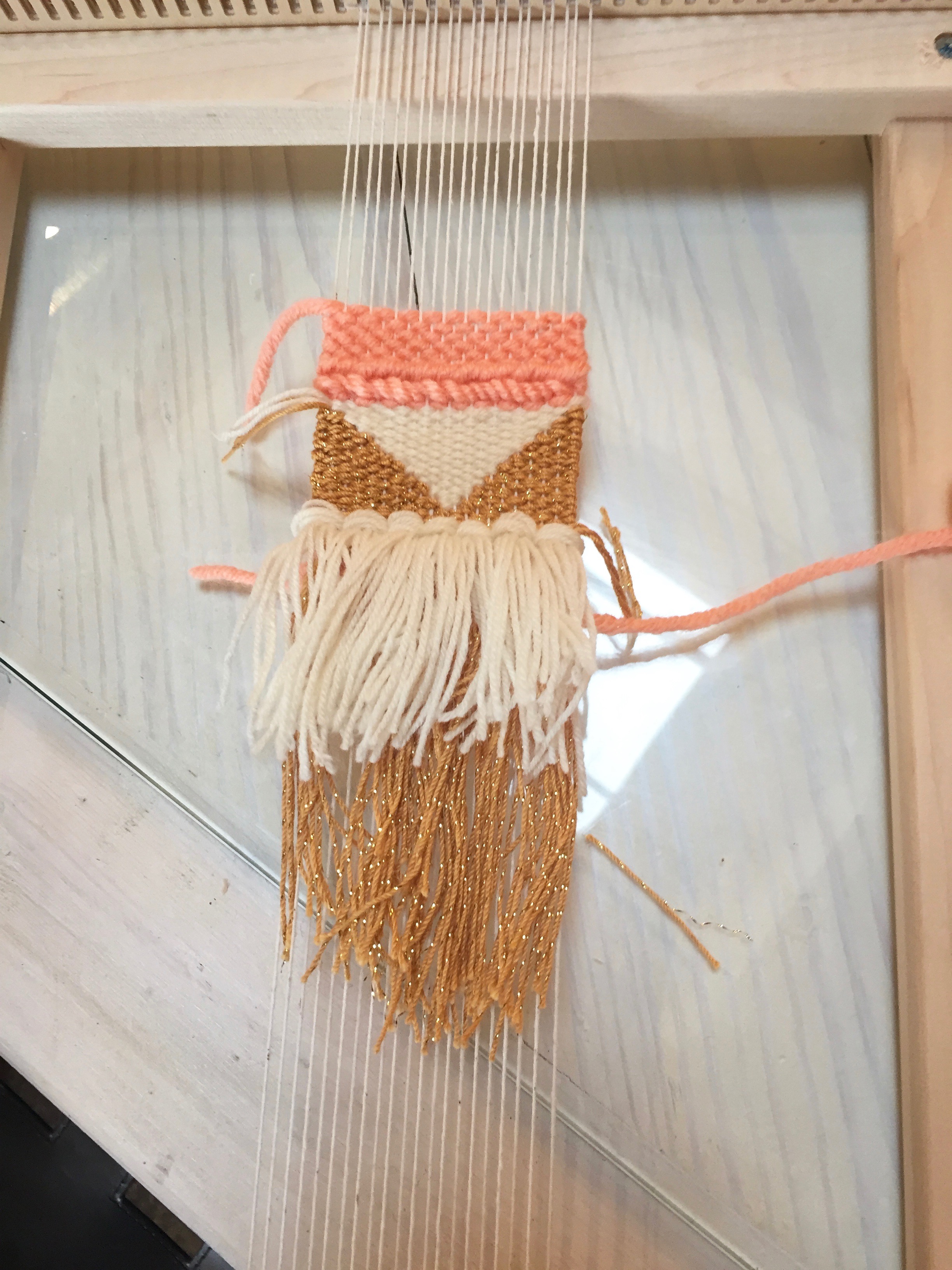 My finished weaving still on the loom, pre weaving in the ends. 