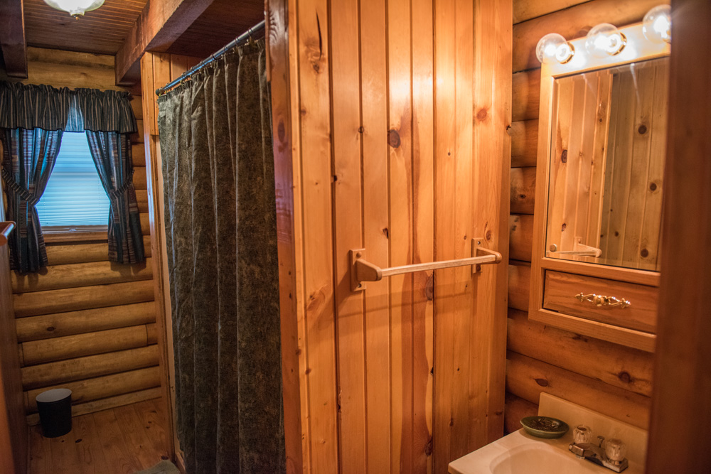  Full bathroom with a walk in shower in an authentic log cabin in Monticello. 