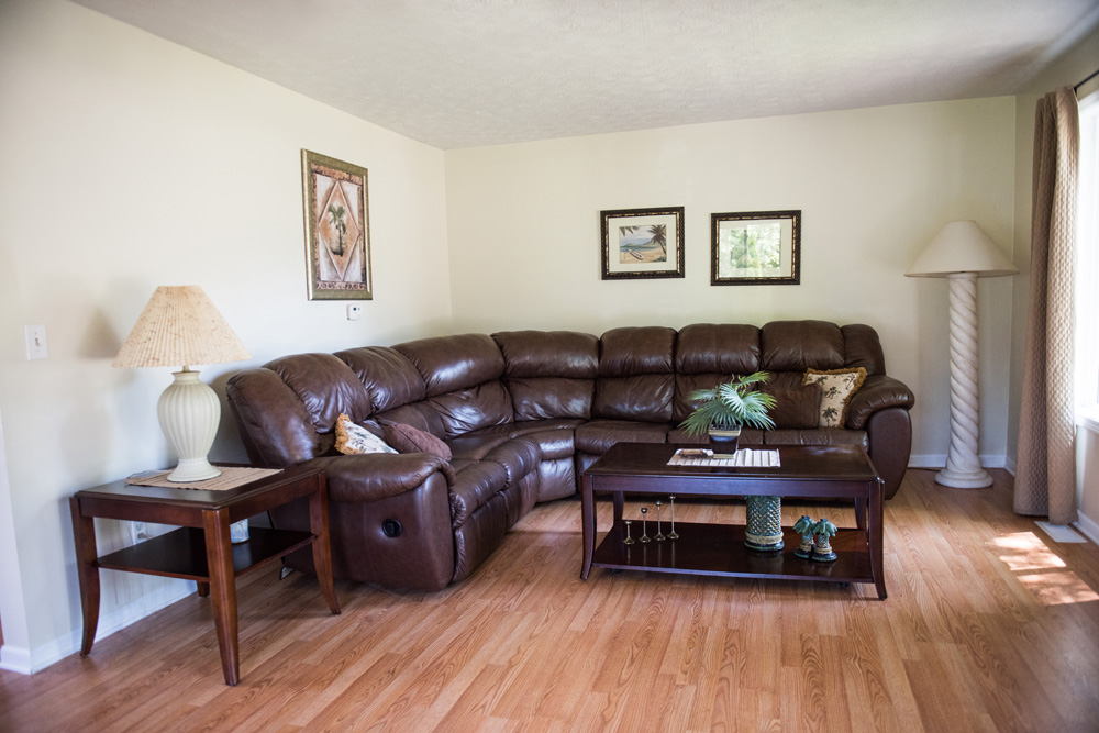  Main living room area with leather couch and television. 