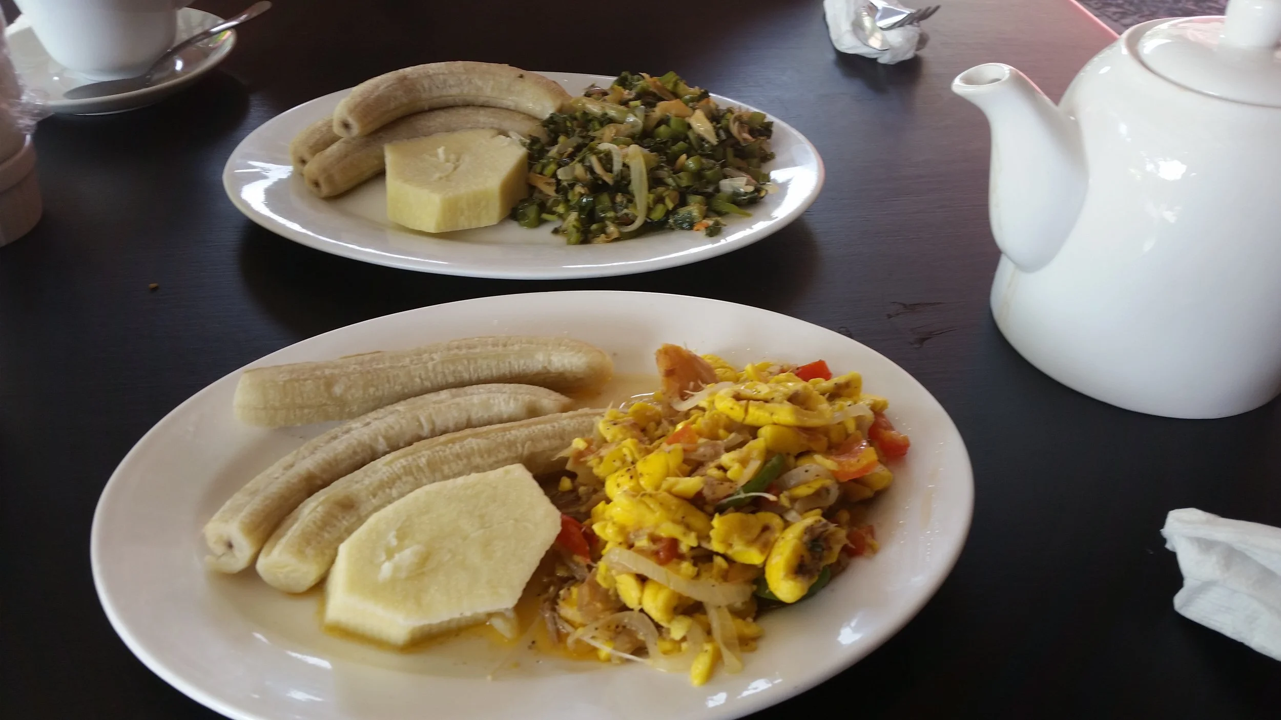 ackee and saltfish, with plantains at front and calaloo and plantains at the back