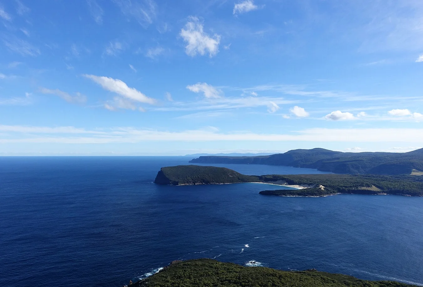 crescent bay and brown mountain in foreground with cape Raoul behind