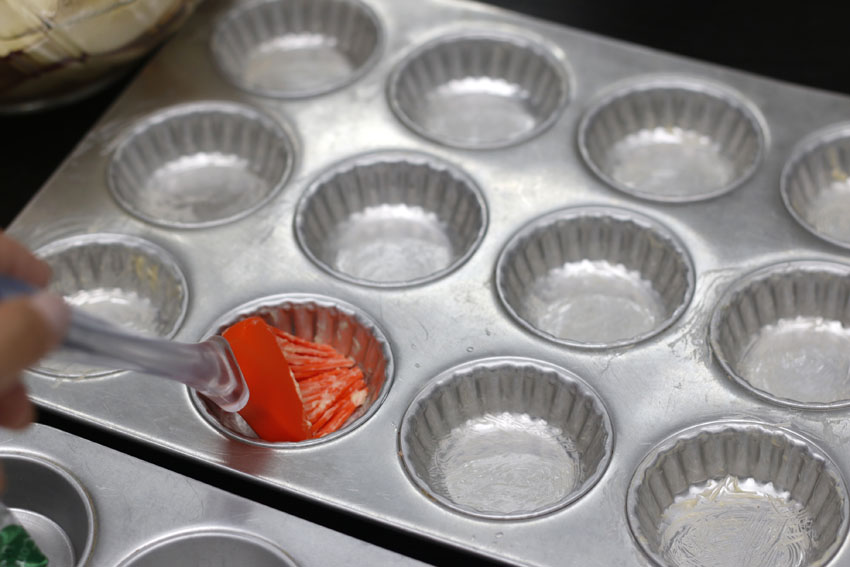 Lightly butter your tin cans (Lightly... too much fats at the bottom will make them soggy, so go easy on the butter)