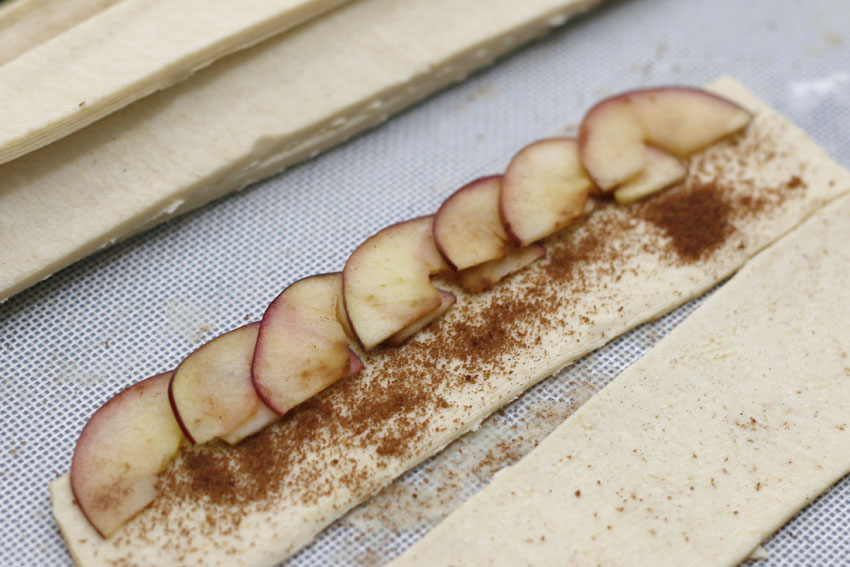 Now, here comes the fun part! Arrange your slices from left to right, making sure your apples are slightly above your pastry. Make sure all the slices are soft and bendable. If they are crunchy, and hard to bend, put them back in the microwave for a few more seconds :)