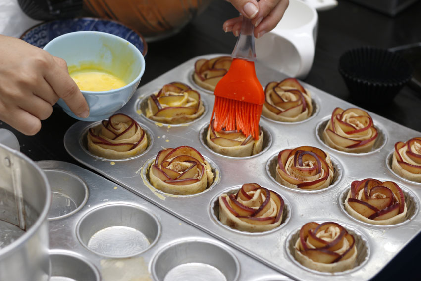 With 1 egg yolk in a bowl, add some milk/water to dilute the mixture, and make sure the top and sides of the pastry is covered. This step will ensure that your pastry turns golden brown.