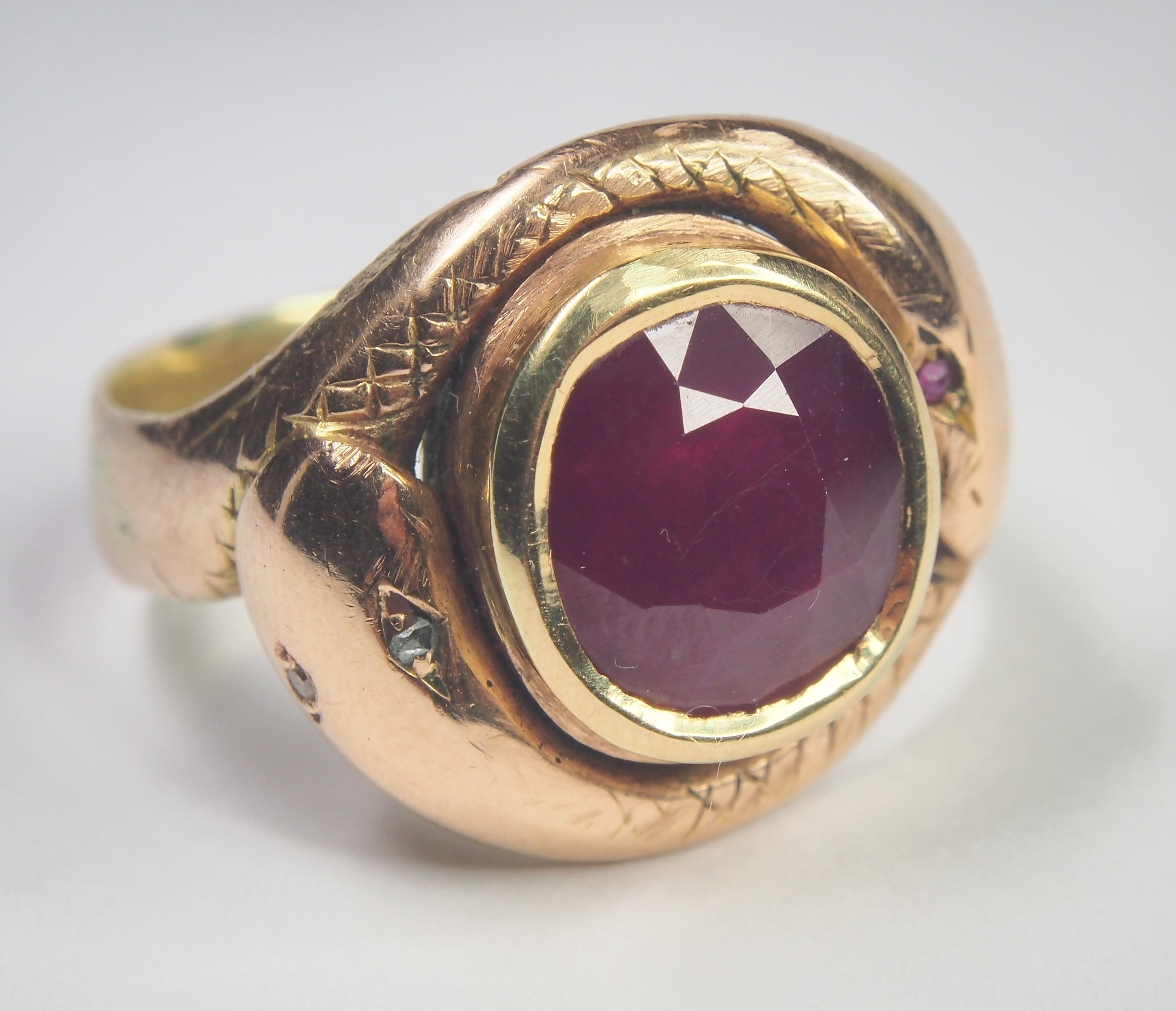 Antique serpent ring containing a modern glass filled ruby