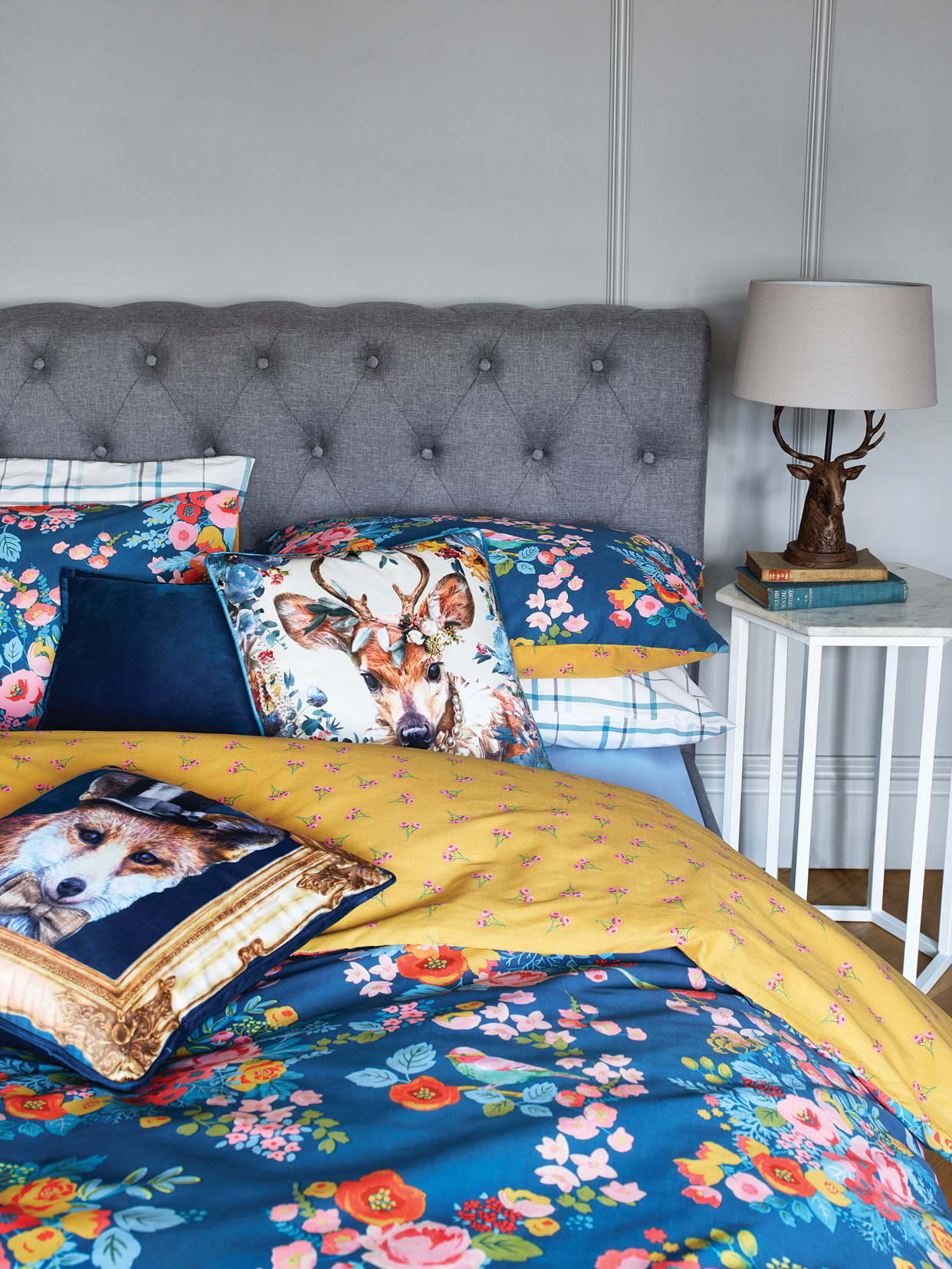 Chesterfield bed - £239, Bird and Floral double duvet set - £12, Deer cushion - £6, Blue velvet cushion - £5, Fox in a frame cushion - £6, Marble side table - £59, Stag head lamp - £27.