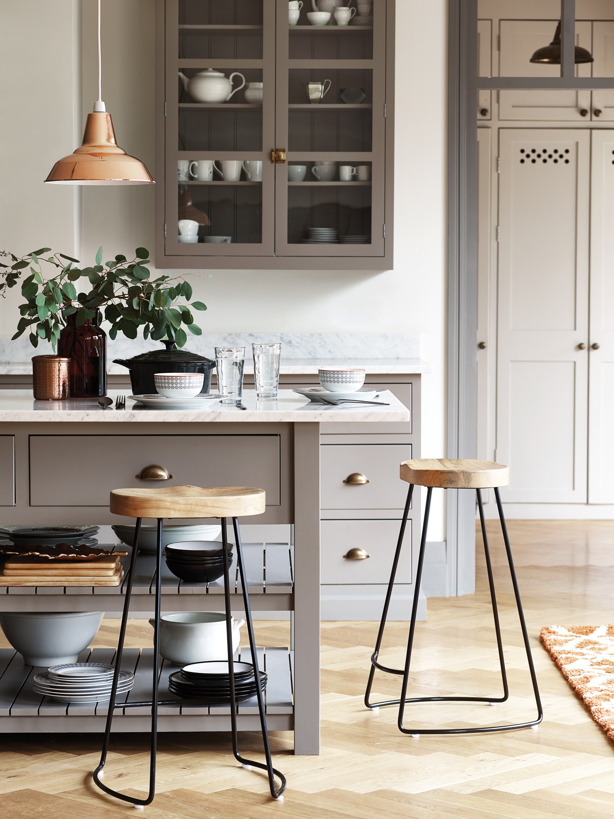 Copper pendant light - £10, Copper canister - £4, Amber glass vase - £6, Black casserole dish - £35, Hiball glasses (set of 2) - £6, Geo edge dinner set - from £6, Matt black cutlery (16 piece set) - £20, Liquorice 12 piece dinner set - £10, Wooden chopping boards (set of 2) - £5, Copper leaf plate - £12, Crafted barstool - £59, Homemaker orange shaggy rug - £25.