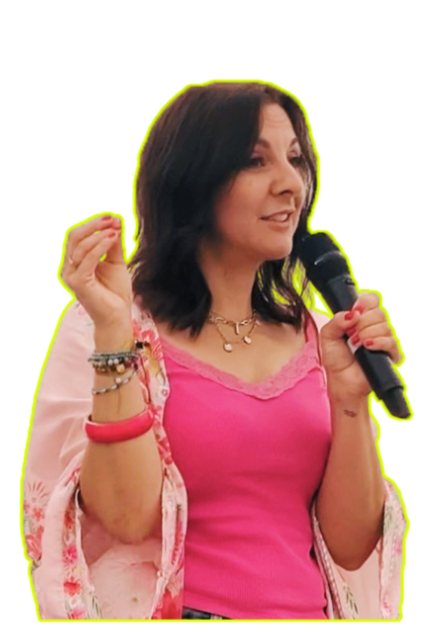 A woman with dark hair wearing a pink top and jewelry, holding a microphone, and gesturing with her hand.