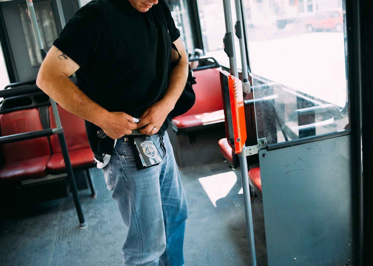 Andrej fits his old police badge, or possibly a replica, to his belt. He wore it as a badge of honour, proudly showing it wherever we went.