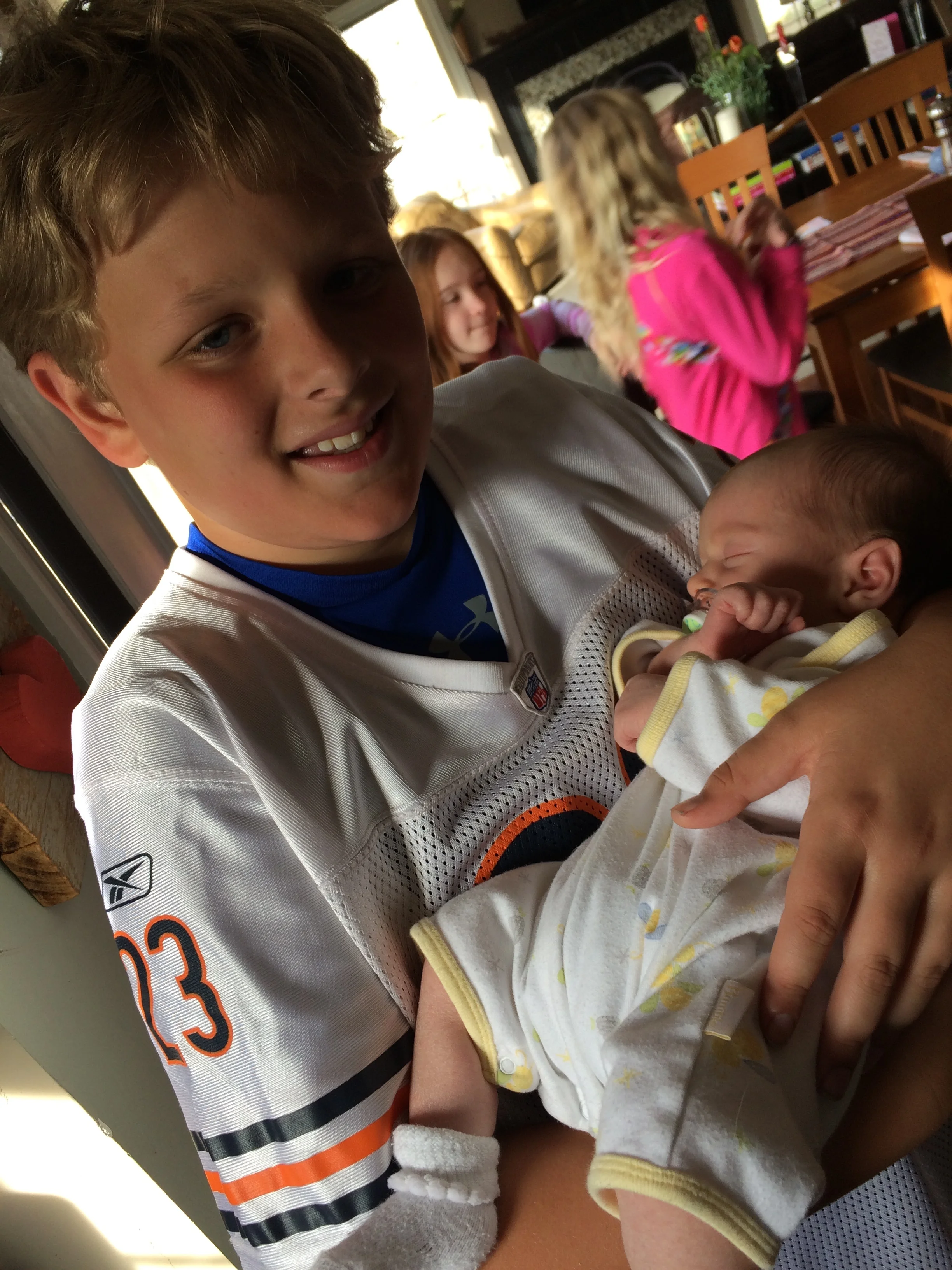 Football jerseys and babies: Sam's model for the modern man.