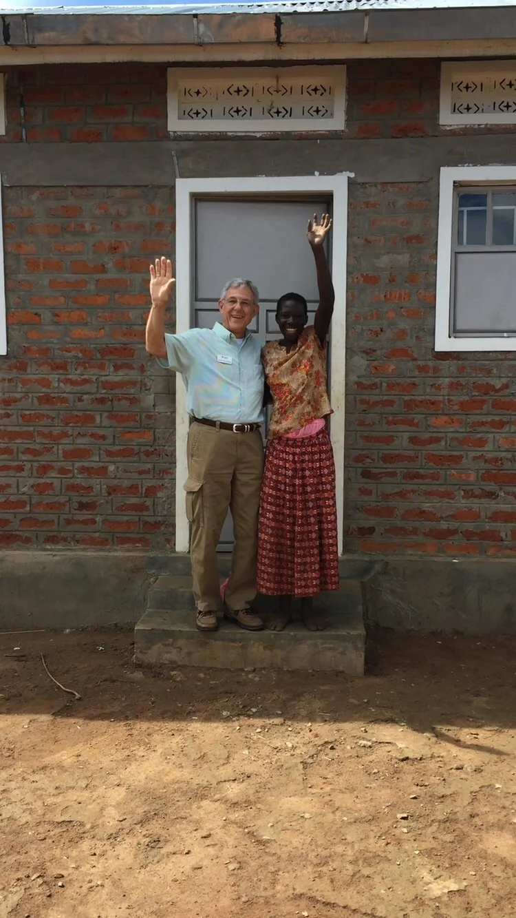 Grace, and our friend David in front of her new home.