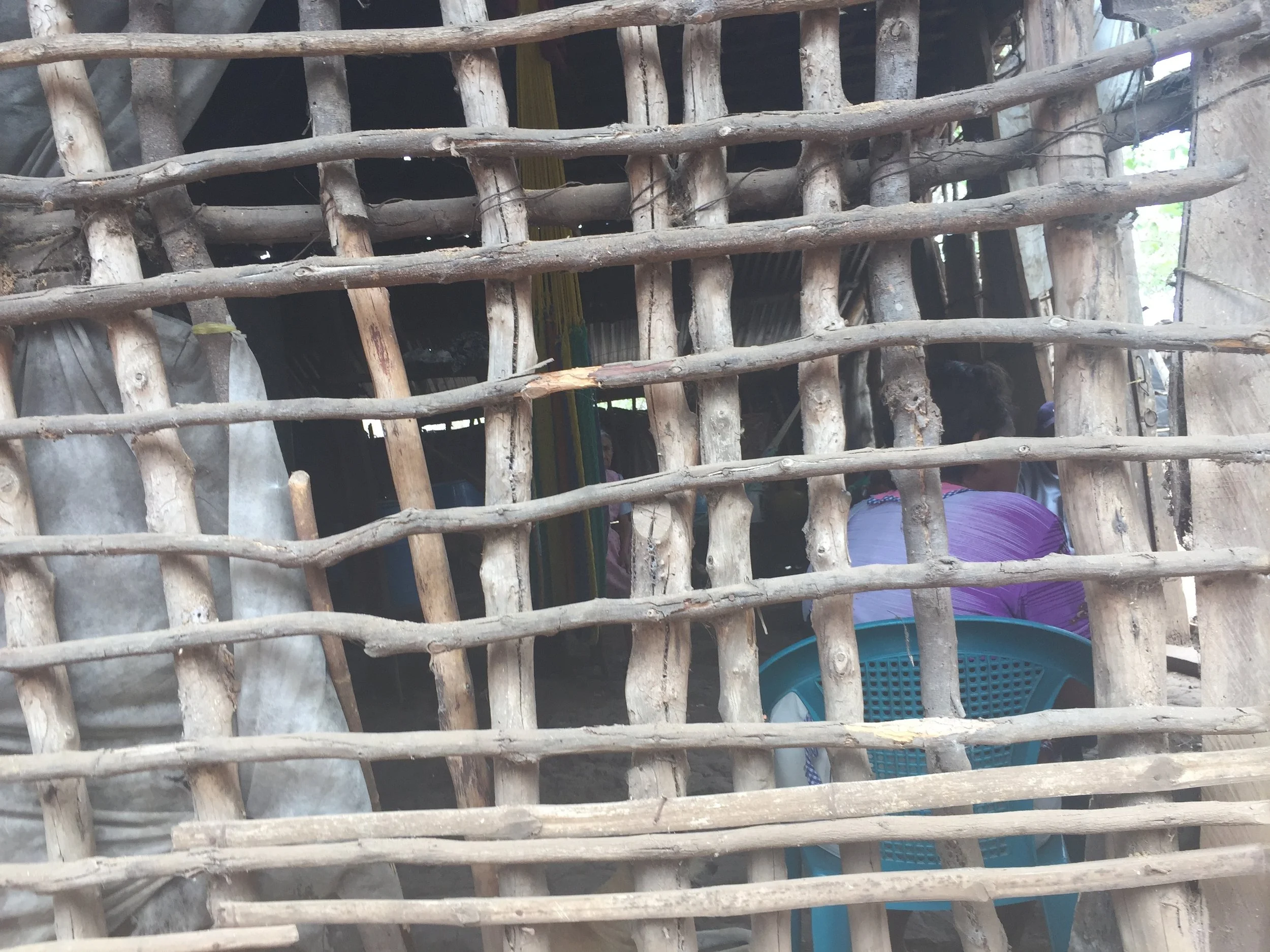 Elderly women gather in their home, where the roof may protect them from sun and rain, but there is little in the form of other shelter here. 