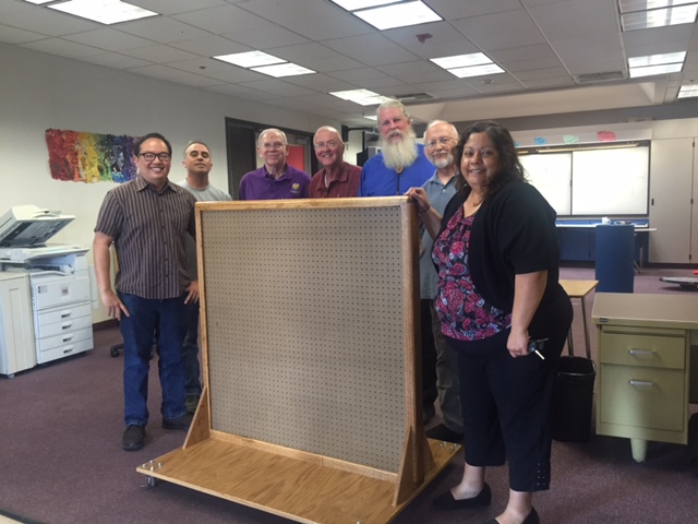 Brothers present the pegboard to Ms. Maria Reyes, special education teacher for RCOE.