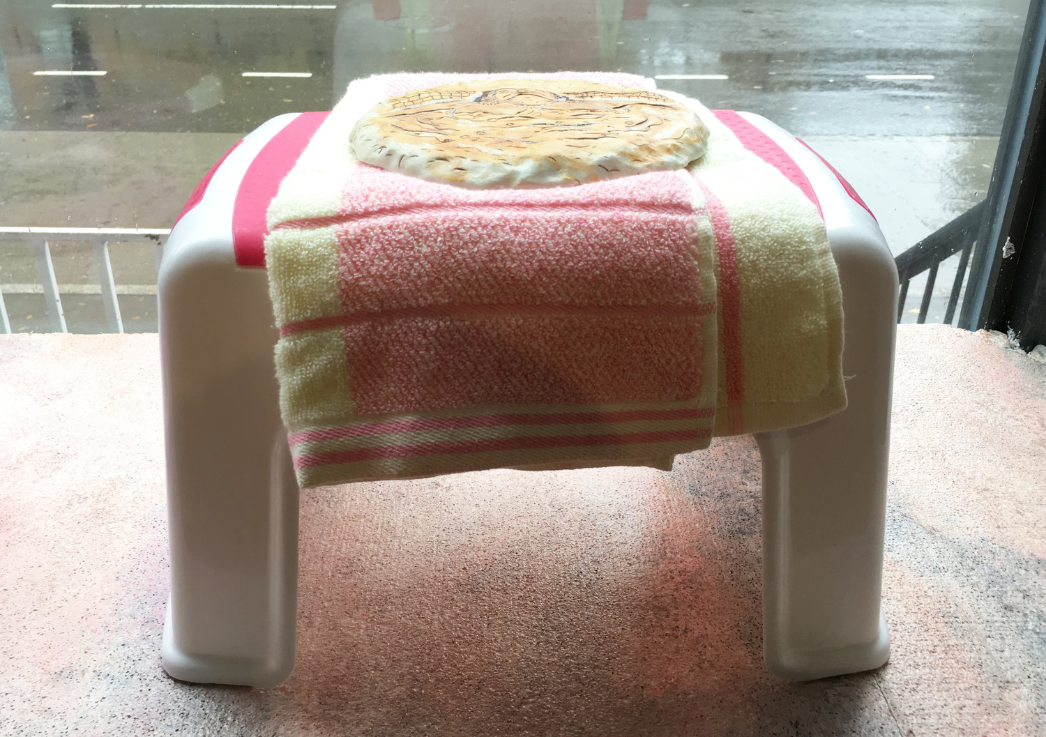 In my mind... I'm underneath warm jets..., 2016 glazed porcelain, towel, plastic stool 9 1/4 x 14 1/2 x 8 3/4 inches