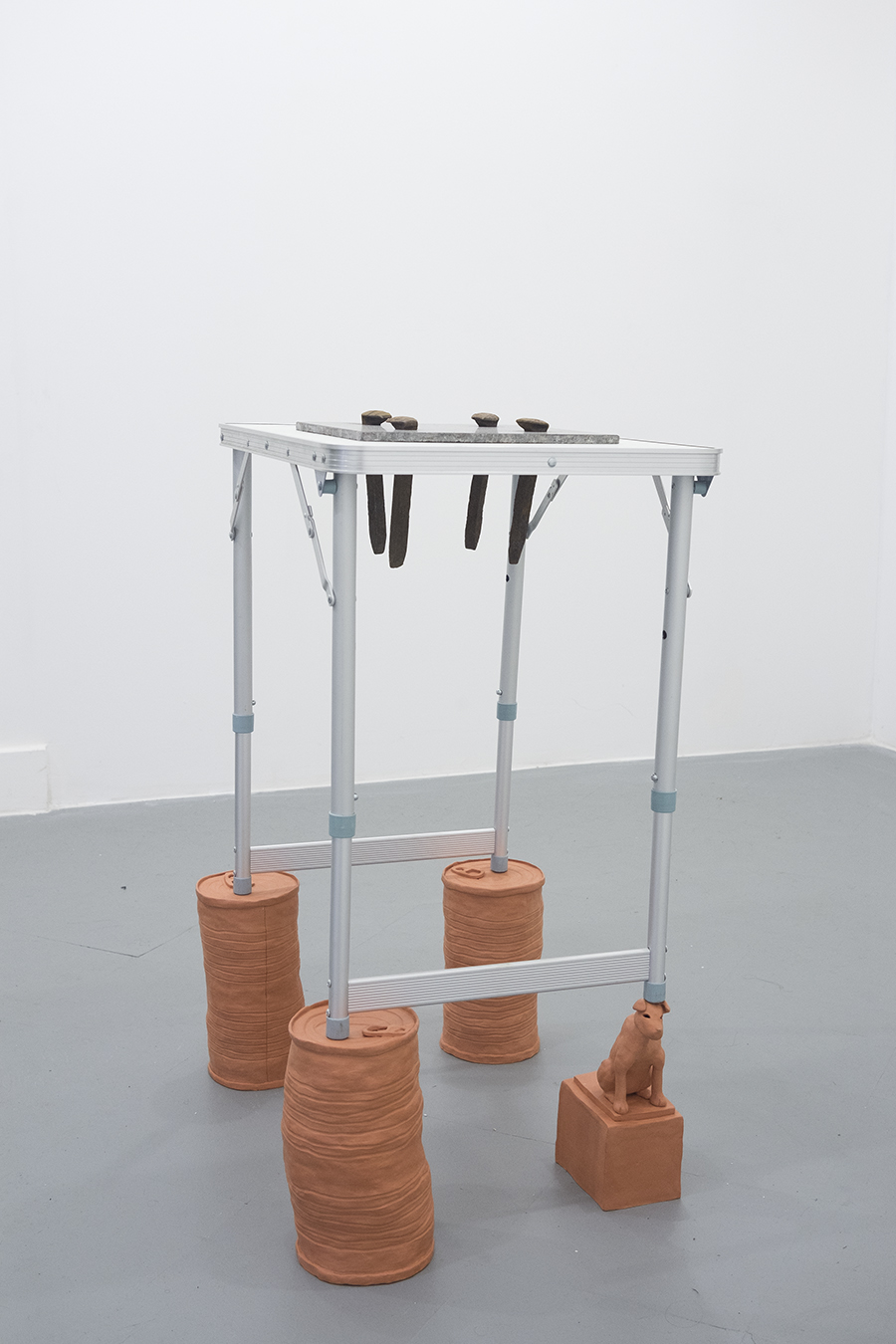 granite countertops / The nail that sticks up / Faithful Dog Hachikō (who waited perseveringly for the return of his deceased owner for more than nine years until his death) , 2018 Granite, aluminum folding table, railroad spikes, earthenware