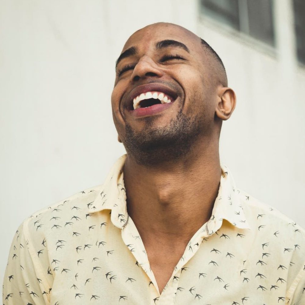 A man laughing outdoors