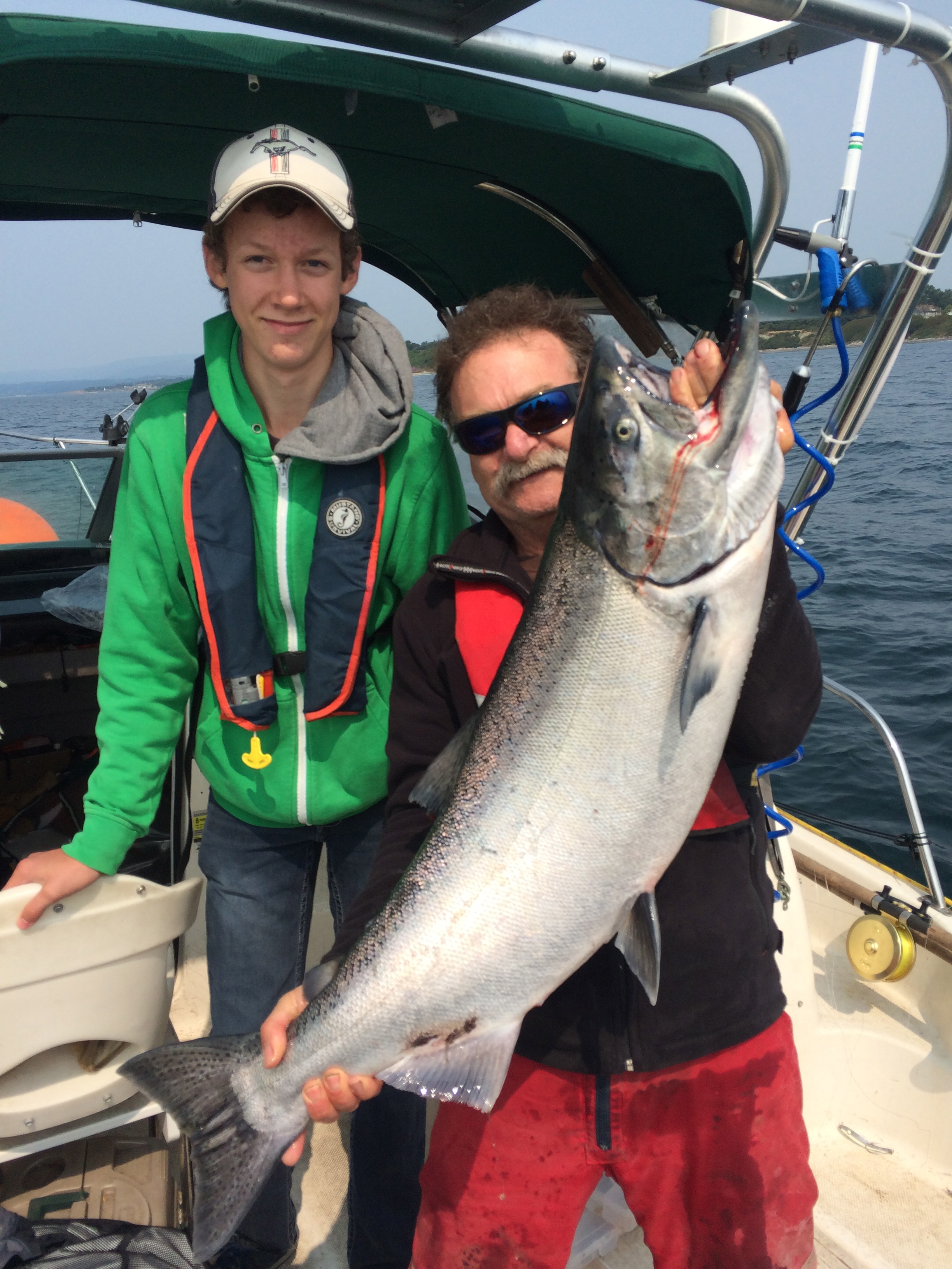 Robert of Great Expectations FIshing Charters with a beautiful Chinook salmon off the Victoria Waterfront.