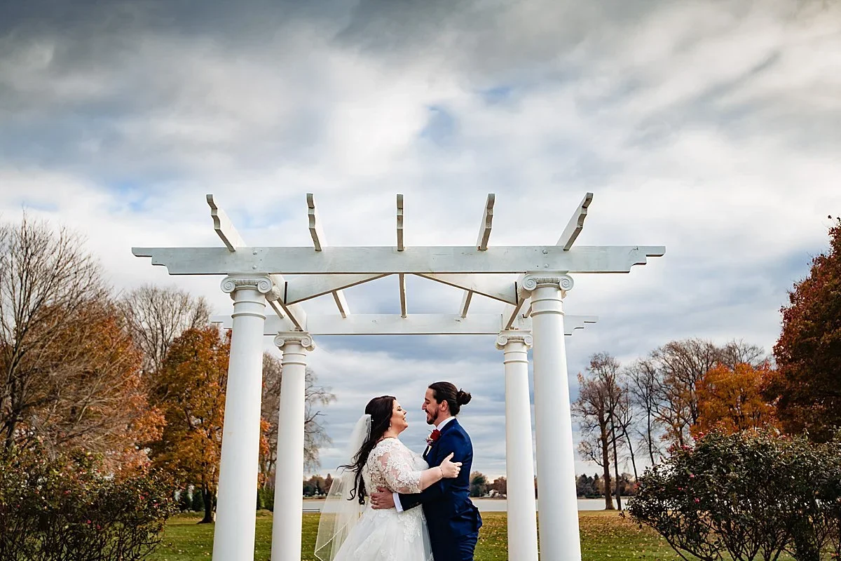 Miranda and Bill under the white pergola on a windy autumn day at Pen Ryn Estate