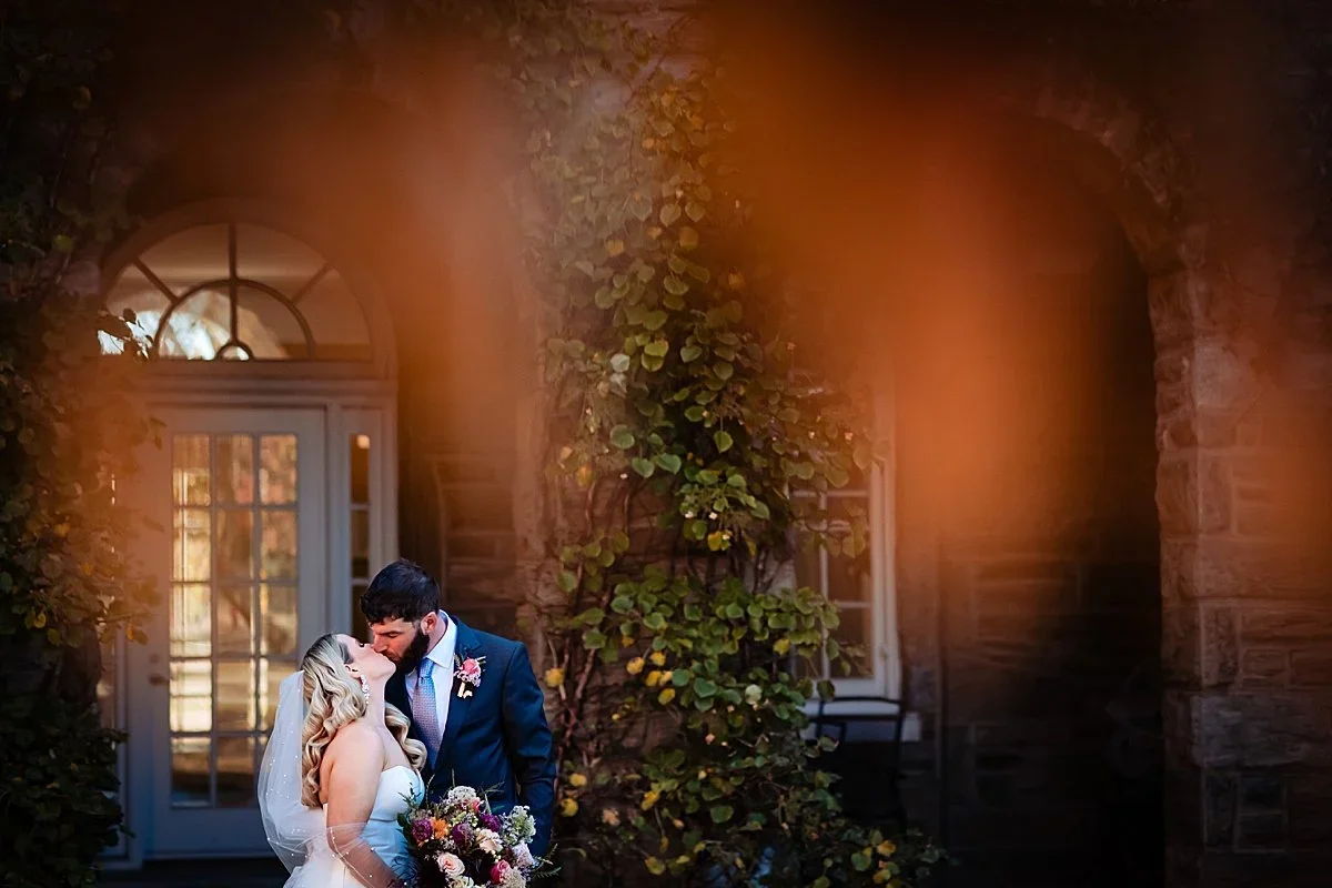 Couple framed by warm light outside Ballroom at Ellis Preserve