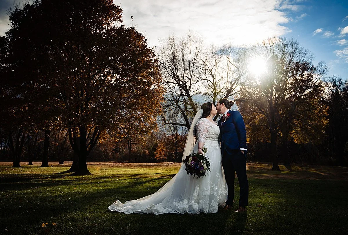 Couple at sunset under the trees on the lawn at Pen Ryn Estate