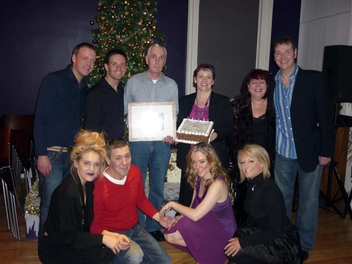 The panto cast with Ian, one of the back stage crew, who was surprised with a cake and gift to celebrate his 50 years at the Palace. L-R back - Andrew Findlater (plays Smiley and Fusspot), Liam Dolan (Director and Josh the Jester), Ian (Backstage, celebrating 50 years at the Palace), Janice Gilmour (Theatre Manager), Brenda Cochrane (Bad Fairy Carabosse) and John Hannibal (Dame Nanny Nora Noo) L-R Front - Laura McMonagle (Prince Valiant), Stevie Hannan (King Bumble), Adele Rankin (Princess Belle) and Louise McCarthy (Good Fairy Azuriel)