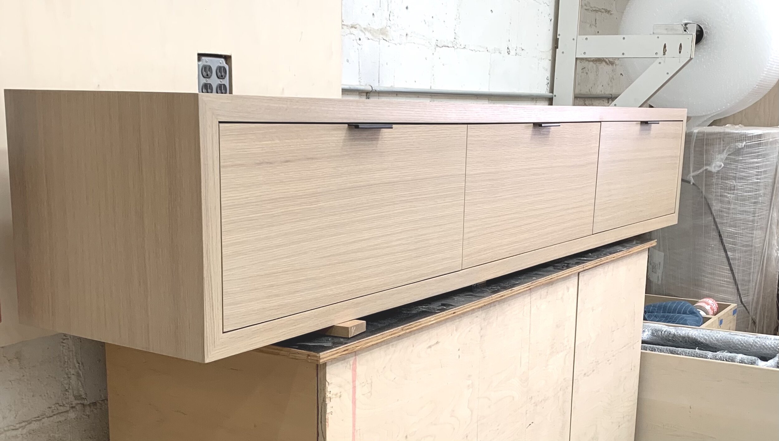 Matching grain white oak wall hanging console for 57 west. NY,NY.