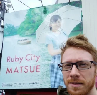 The Photogenic Zachary Scott and a billboard for "Ruby City Matsue" in Shimane Prefecture, Japan