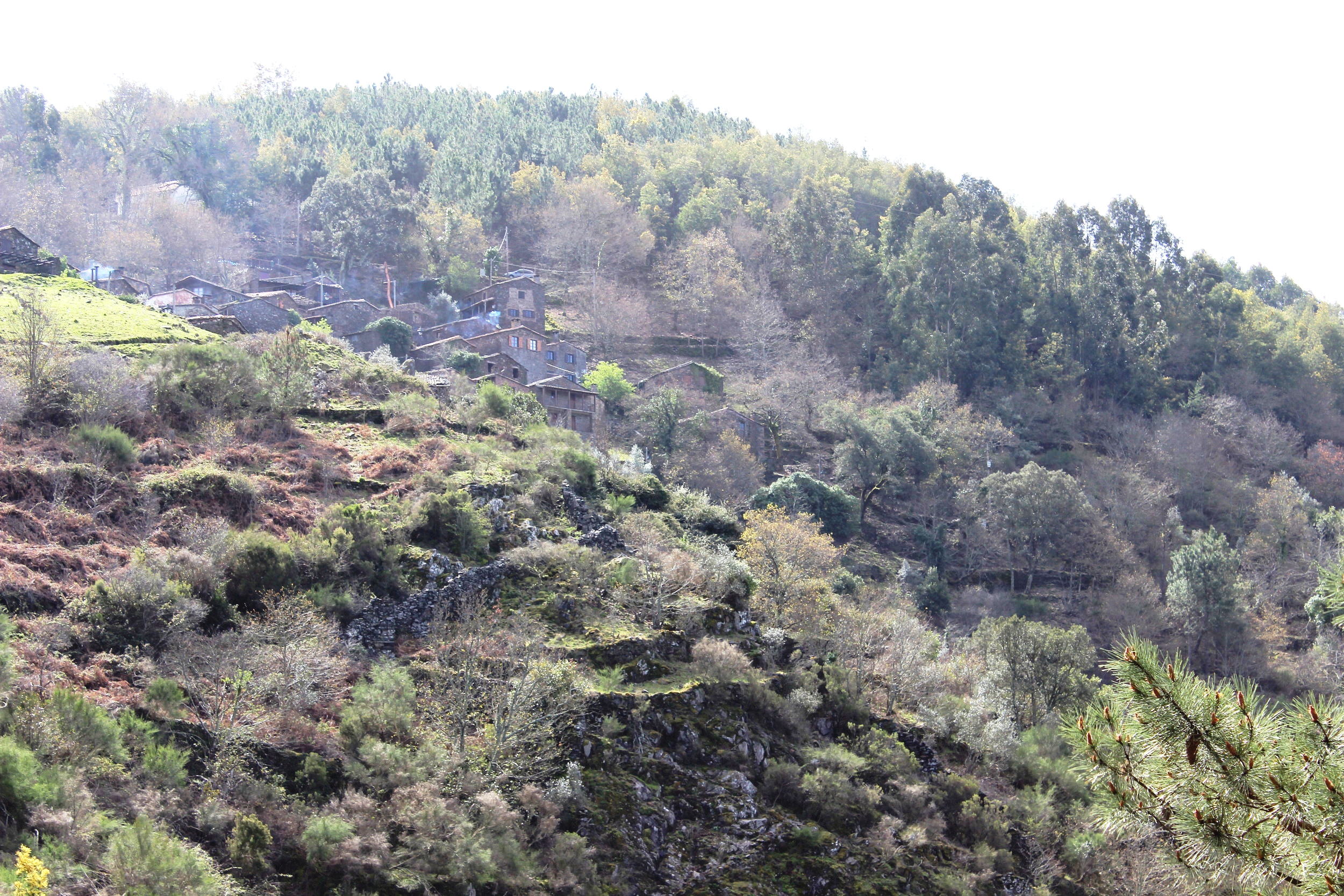 Schist village hidden into the mountain side from afar
