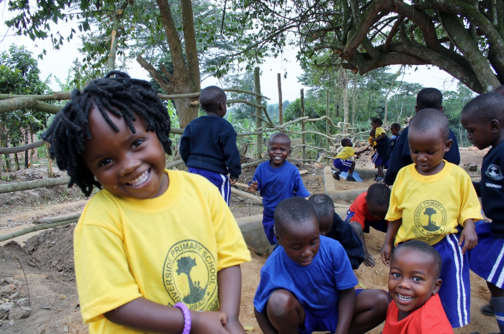 Mbazzi's Early Childhood and Development Class students enjoying their new sand pits.