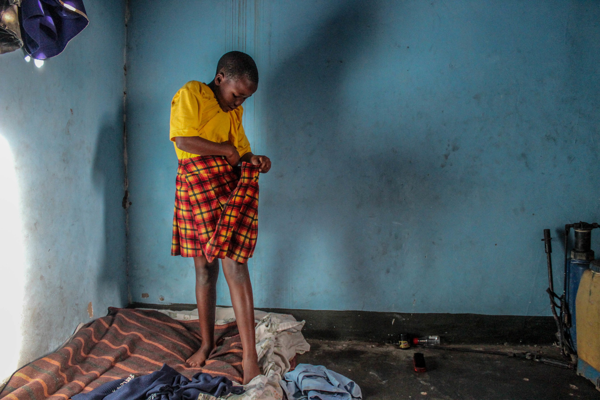 Goretti changes out of her school uniform once she returns home. This is the room Goretti and her cousins sleep in.