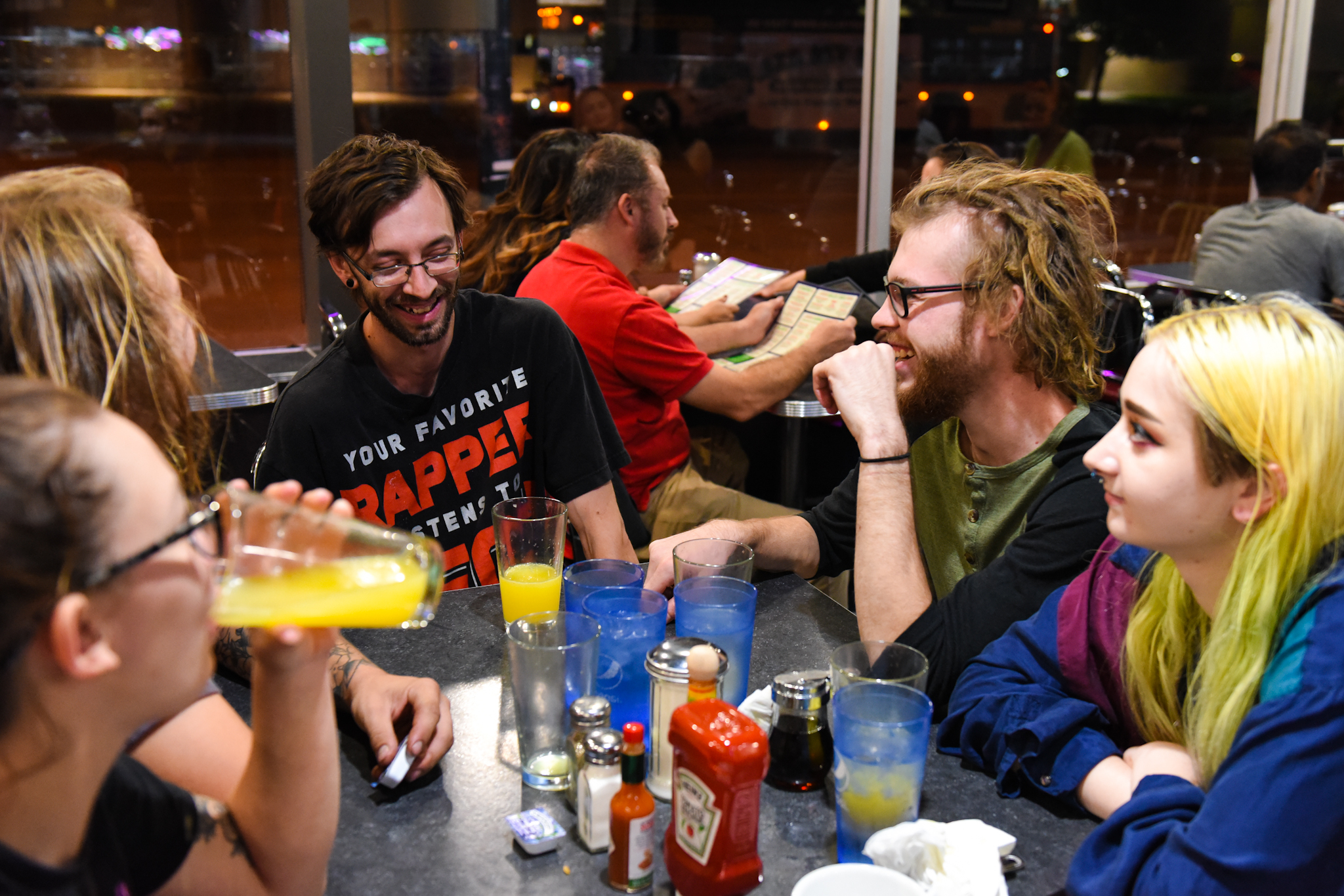 10 p.m.: Friends gather around a table. All are originally from Minnesota, but four currently live in Colorado.
