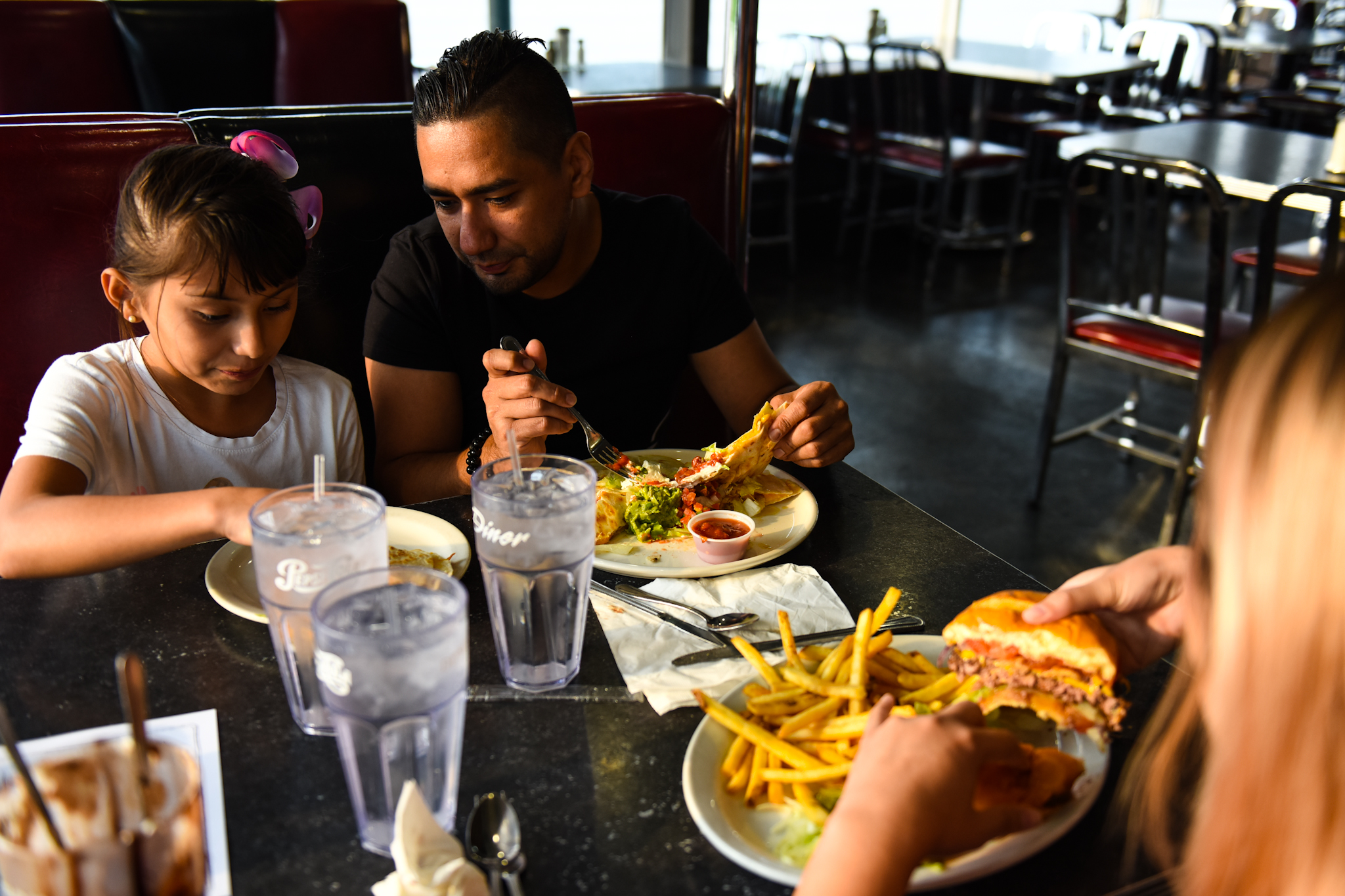 7 p.m.: Members of the Marquez family (Alyssa, left, Chris and Cynthia) order their food, with Alyssa splitting her parents' entrees. They live in Albuquerque but come to the diner when they're in Denver. They'll drive back to New Mexico after their meal.
