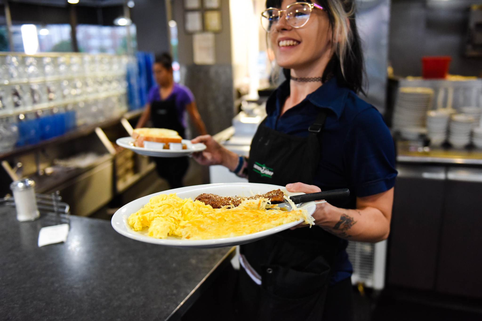 6 a.m.: Heather Blanchet runs breakfast out to a table of three. Blanchet started at the Denver Diner on July 20, two days before her birthday.