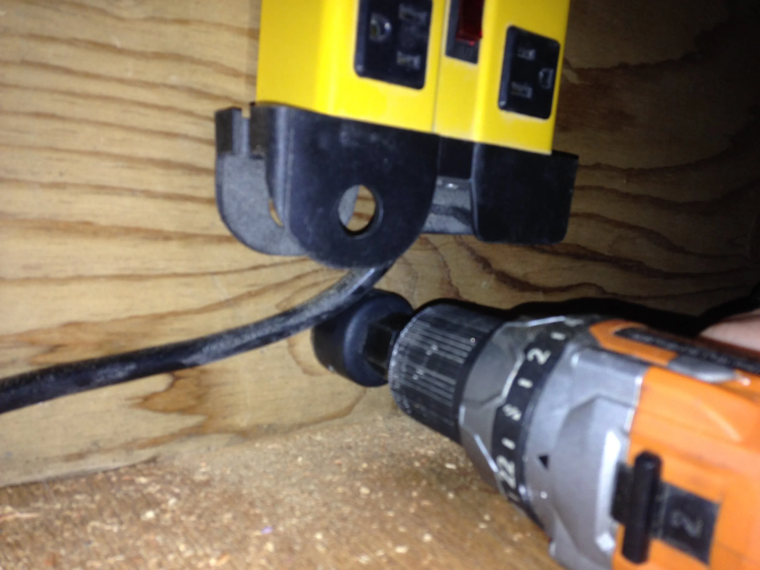 Drilled a hole in the ply wood so the cord from the power bar can pas through. This power bar is the one used for my external hard drives and it plugs into a battery back / surge protecter unit so keep everything safe incase of a power outage. 