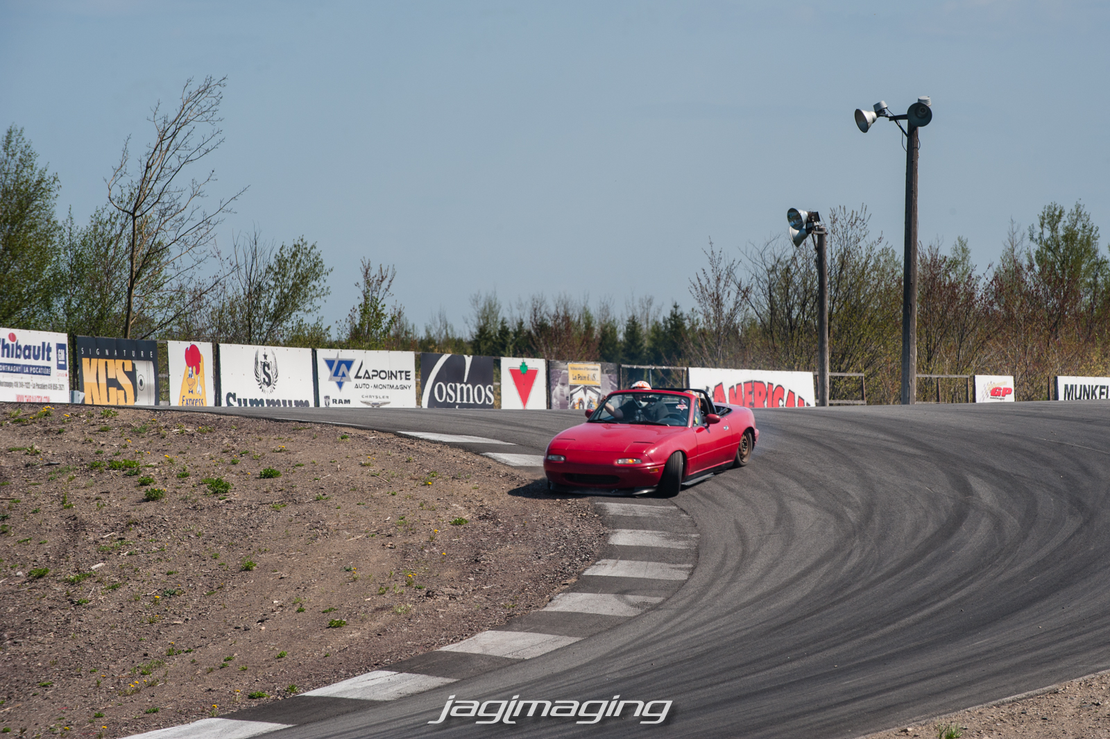 Little Miata about to drop a tire coming down. 