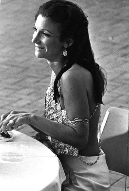 The original Post-Dispatch caption on this photo read as follows: "Colorful and bizarre costumes provided the decorations for the feast. Mrs. Martin Shampaine, who just returned from Italy, arrived in a backless top of metal plates. She sat down quickly, hiding her sandals, which laced to the knees. Lynn T. Spence/Post-Dispatch