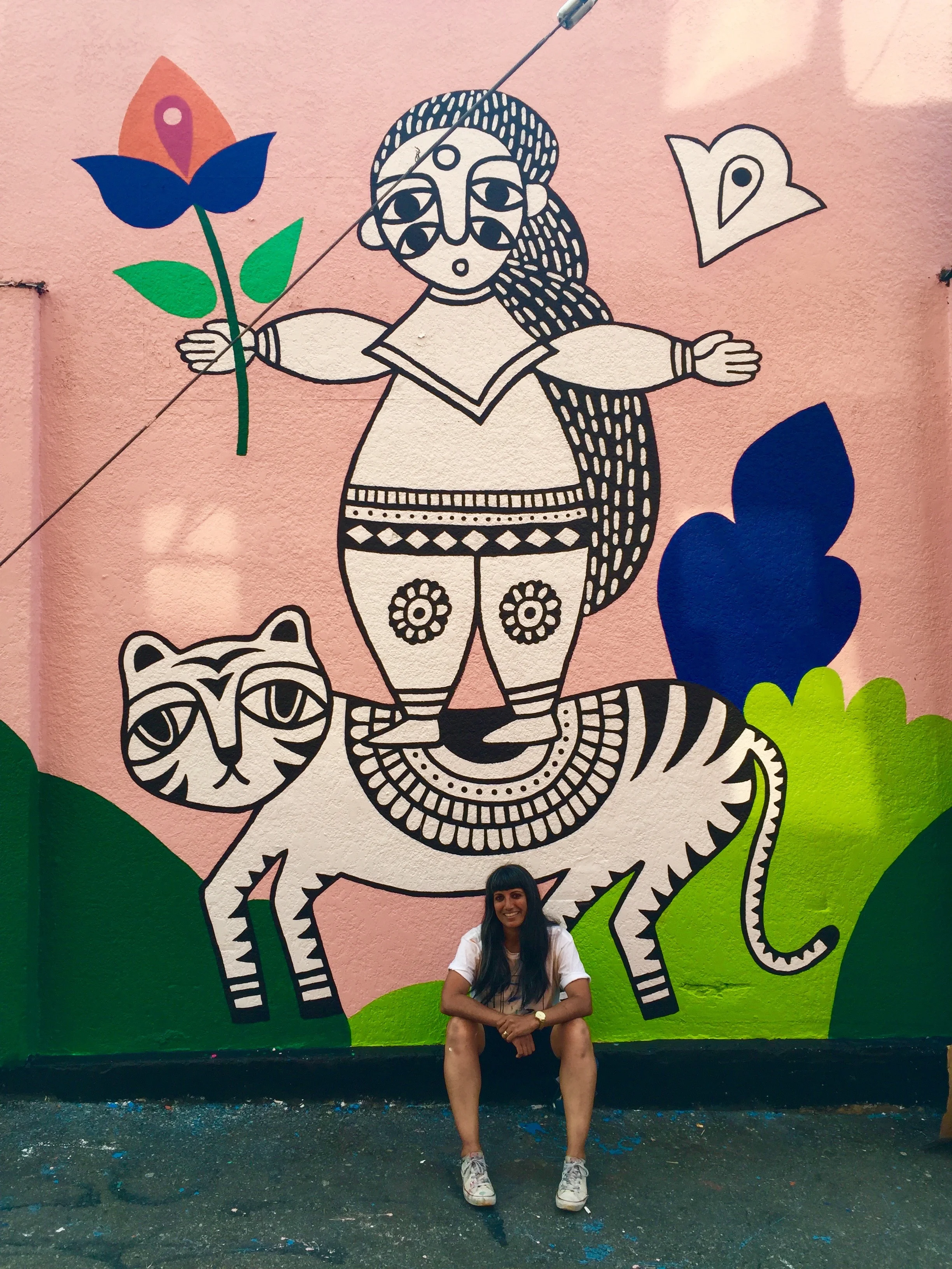 Sandeep and her mural, Girls are Fierce Like Tigers, 2017