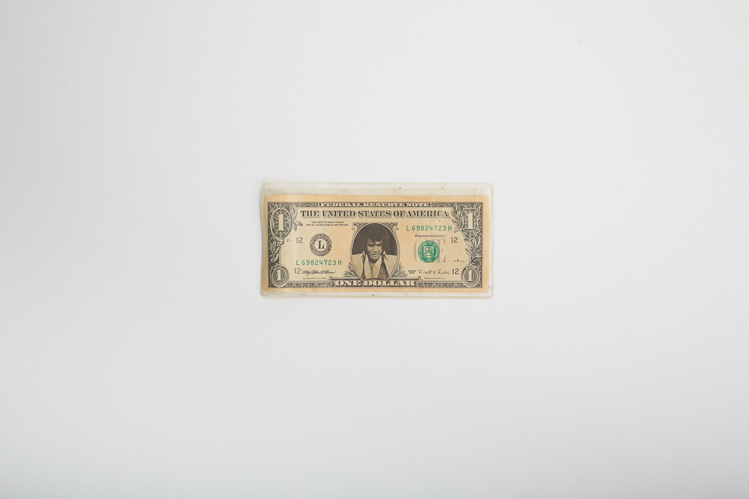 Dollar bill with The King on.