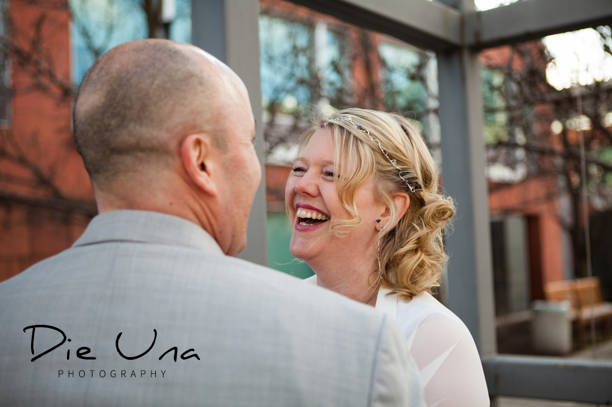 outside at Kitchener city hall with wedding couple