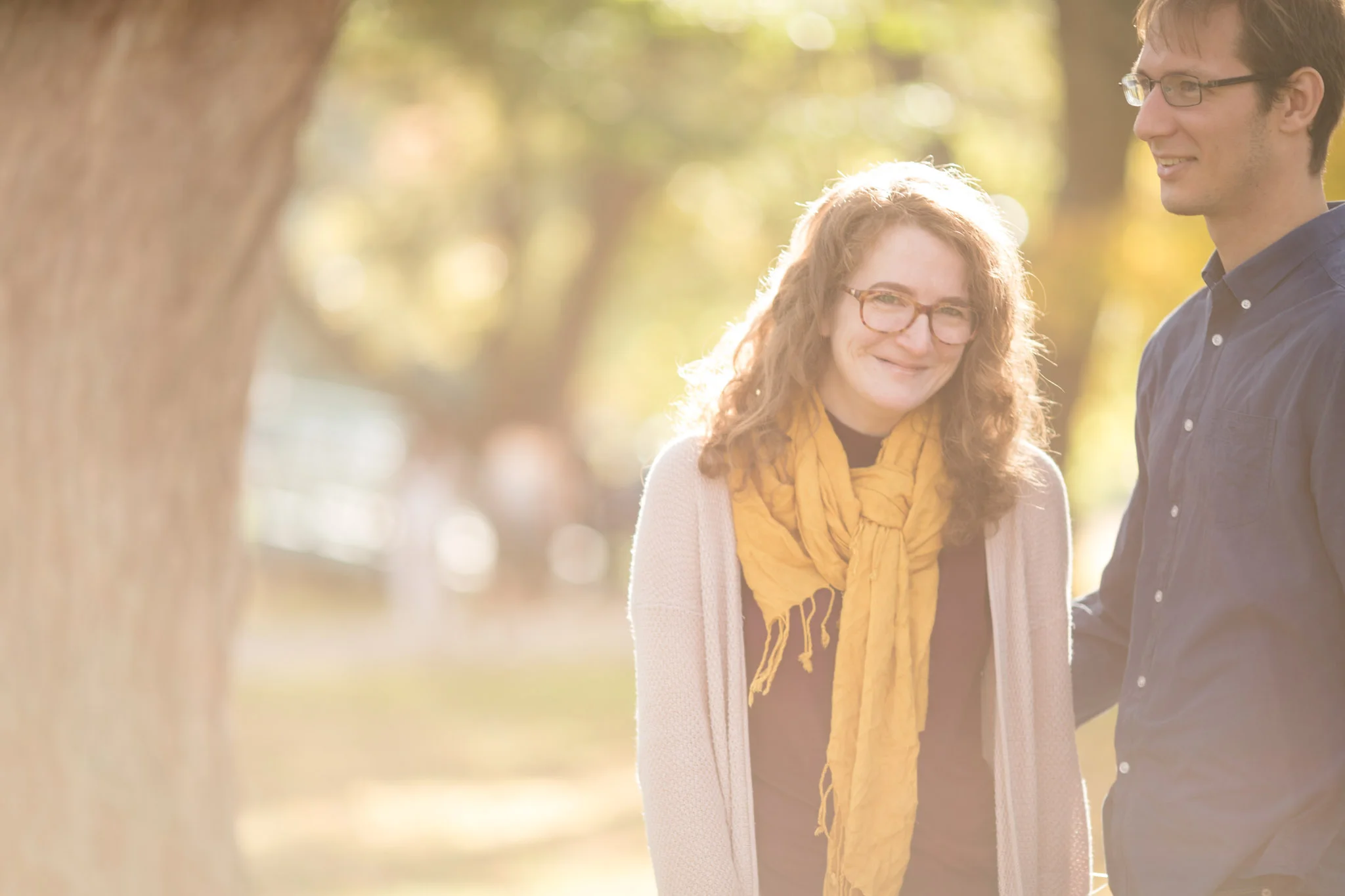 candid laughter while walking in the park with beautiful golden light in Victoria Park Kitchener Ontario.jpg