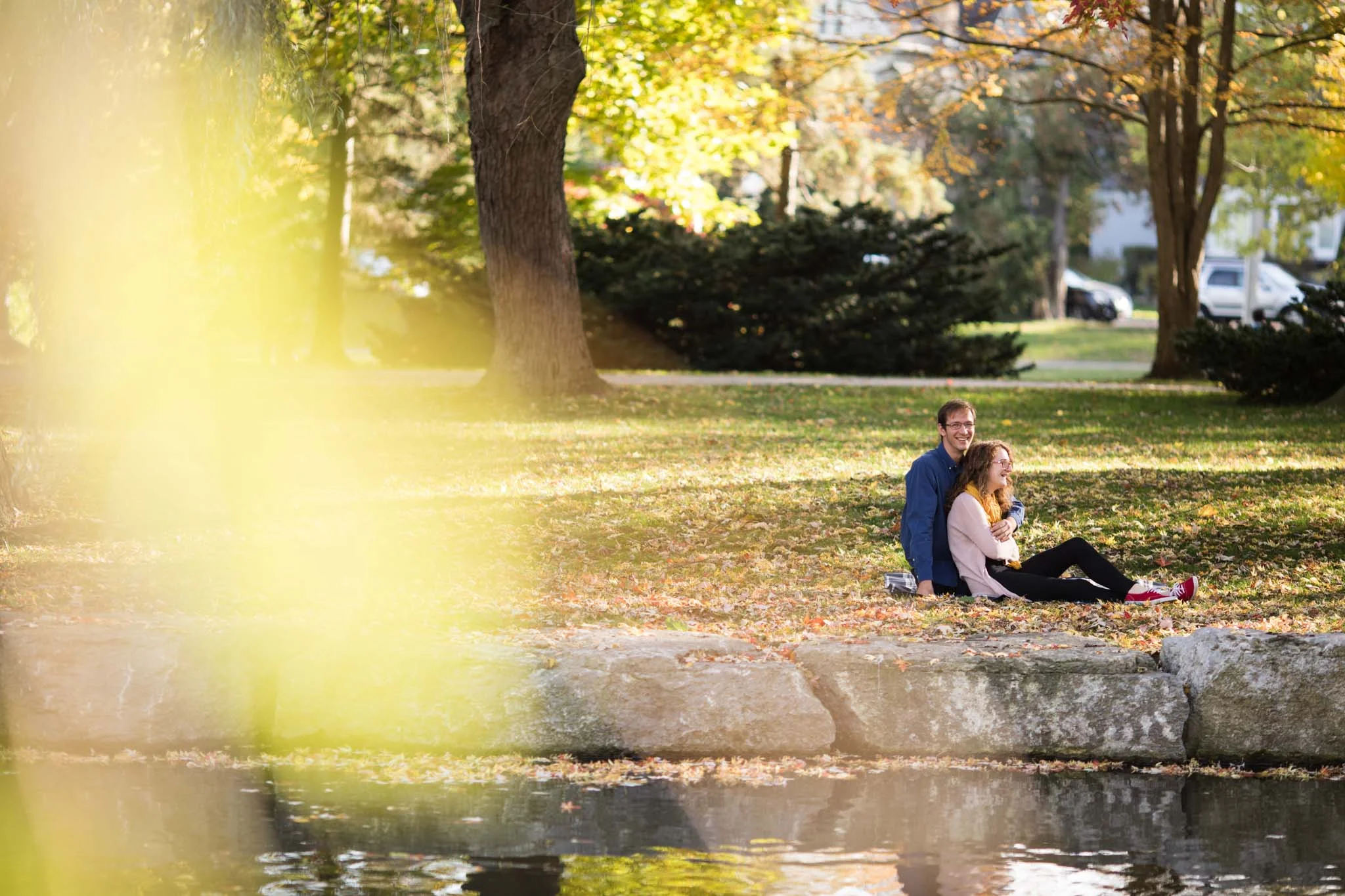 couple cuddling in the park for couple photography session.jpg
