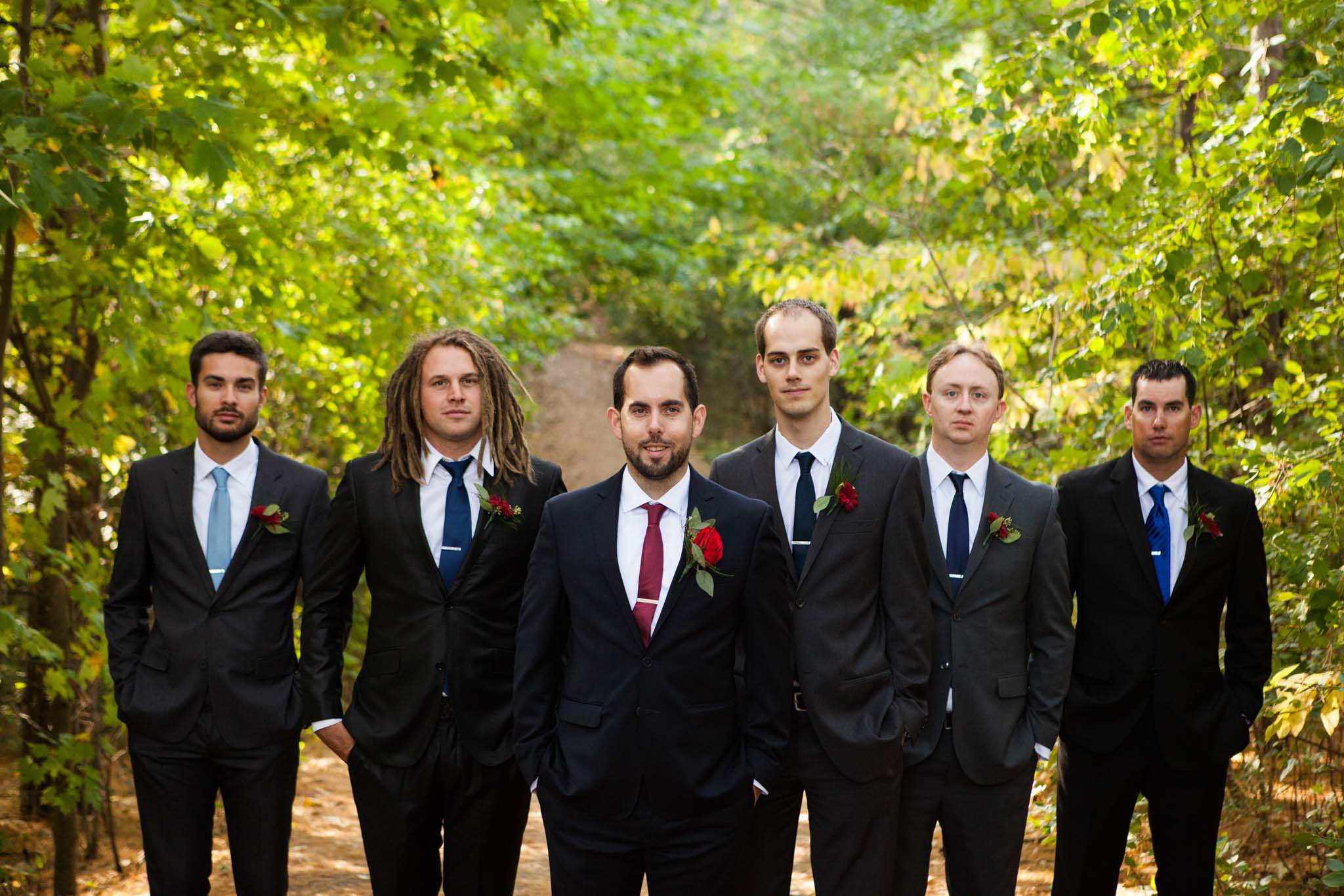 groom and groomsmen portrait in a natural wooded setting.jpg