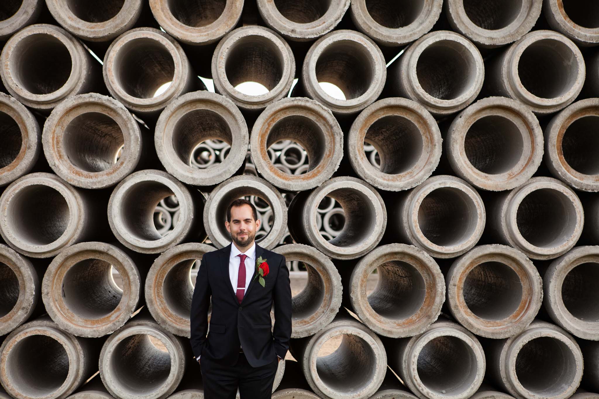 groom portrait in industrial concrete pipe setting - wedding photography.jpg