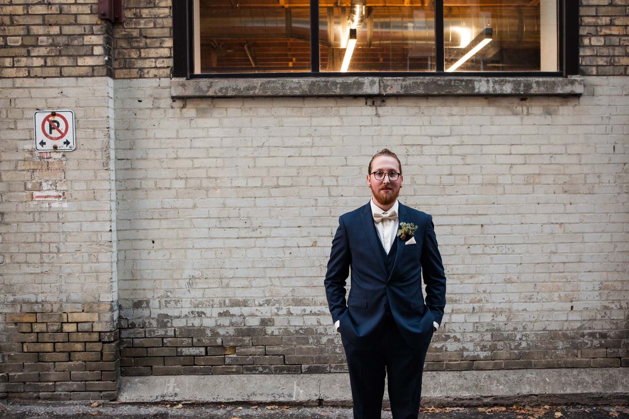 groom wearing blue suit and top knot wedding portrait.jpg