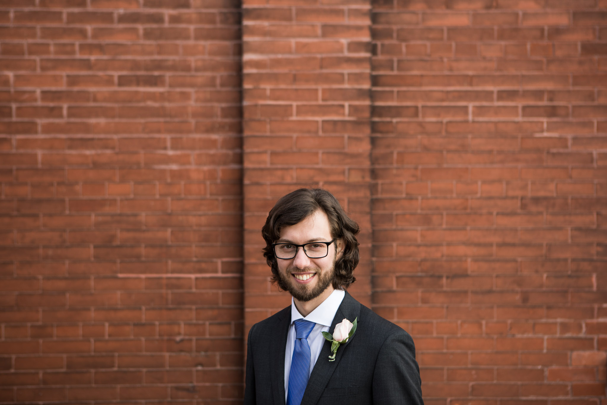 wedding photography groom portrait against redbrick wall in Paris Ontario.jpg