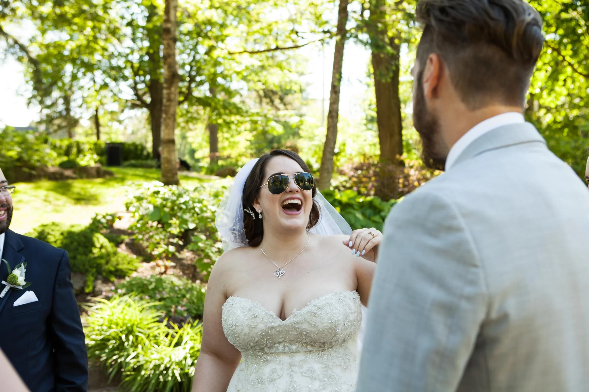 bride wearing aviators and laughing candid wedding photography.jpg