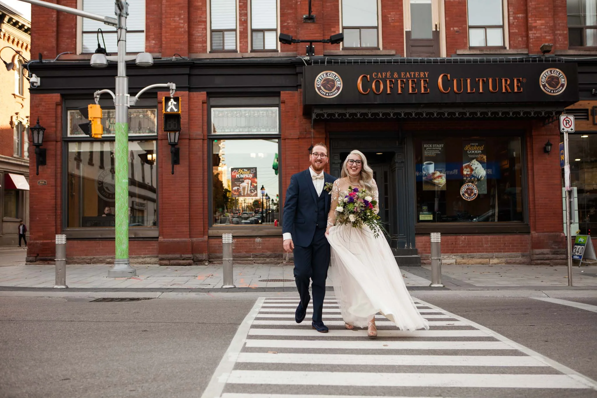 hipster wedding couple crossing the street in the DTK downtown Kitchener.jpg