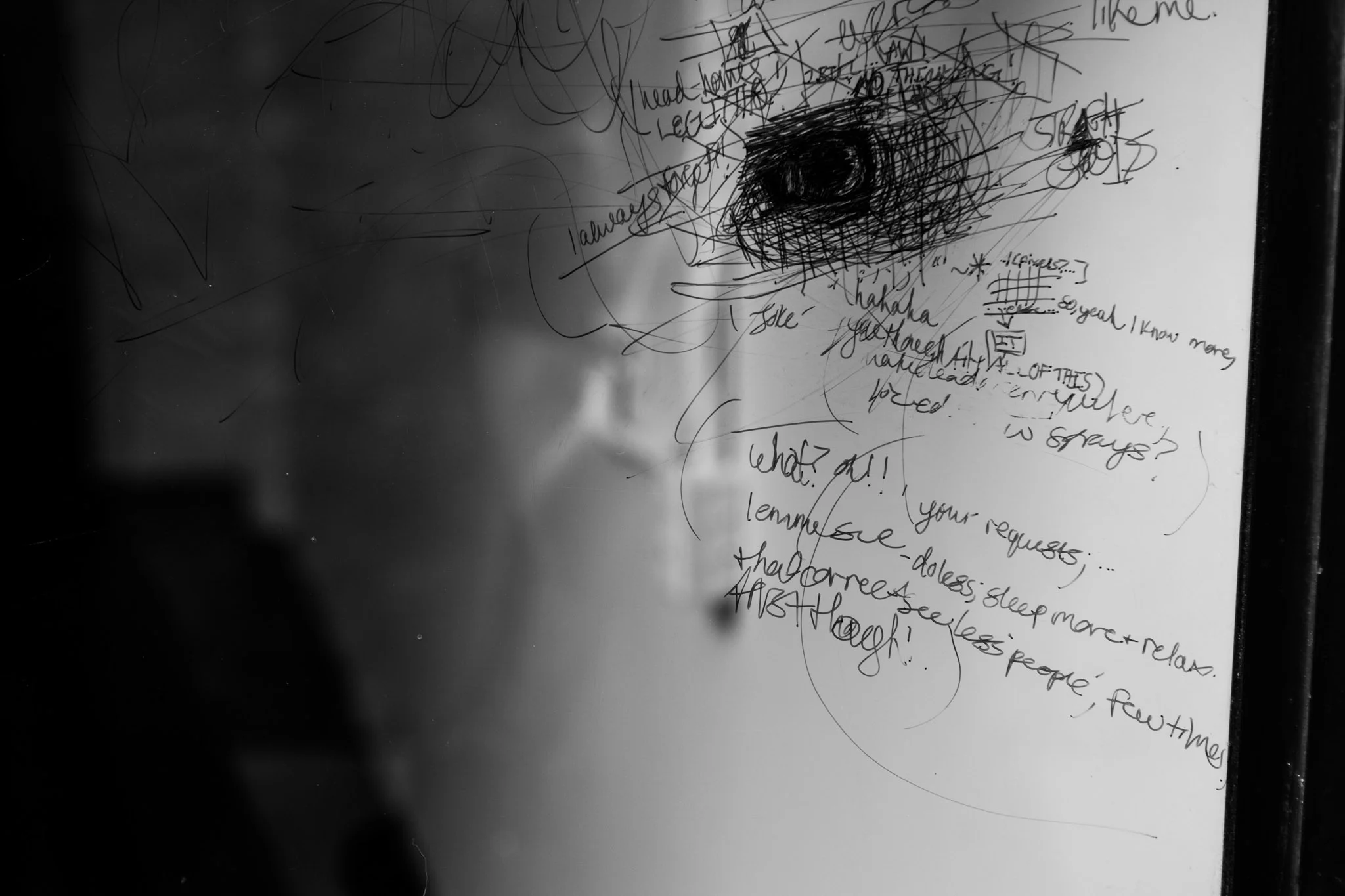 black and white ink vandalism on a glass wall.jpg