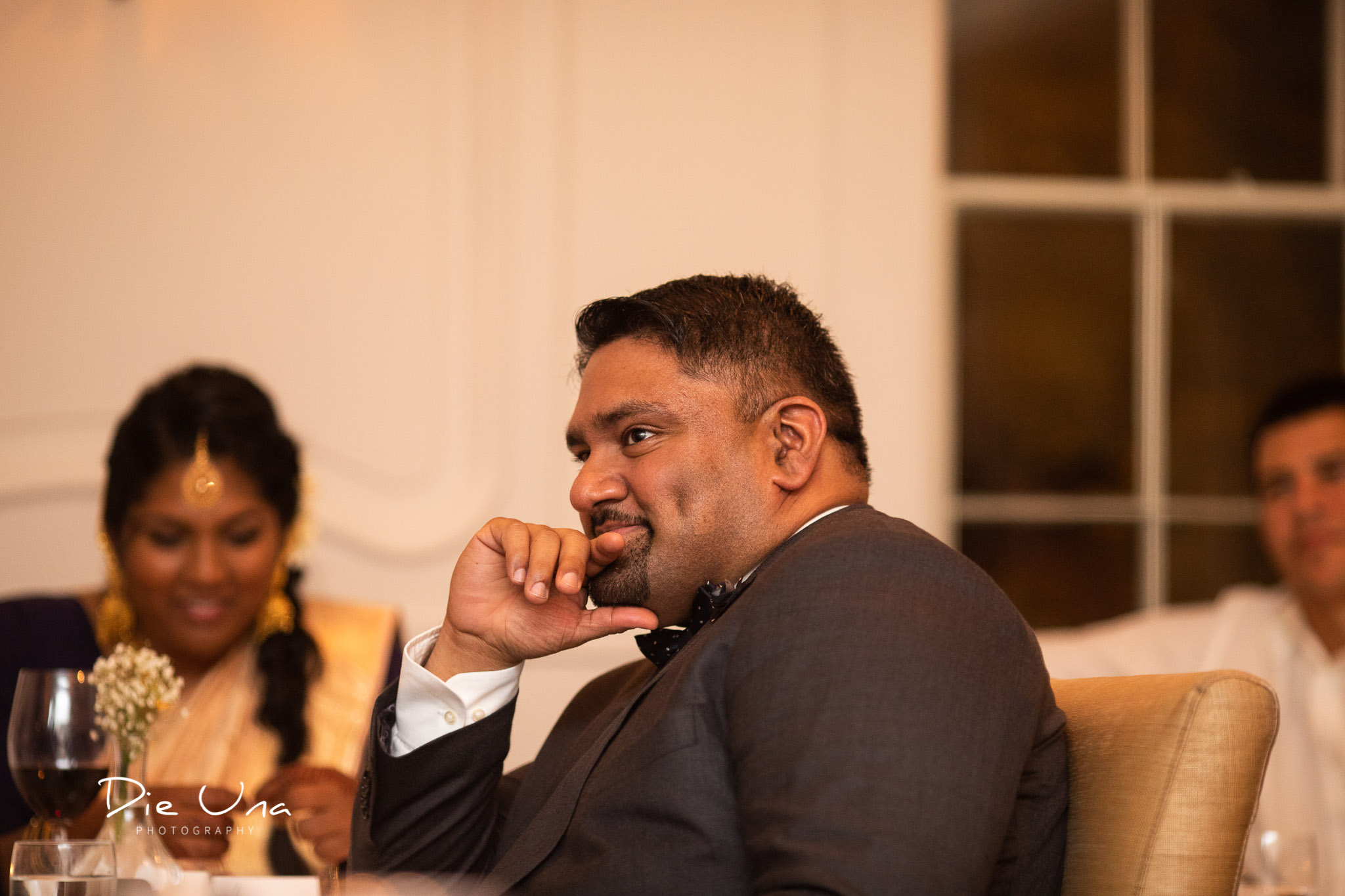 best man with a thoughtful look on his face during speeches.jpg