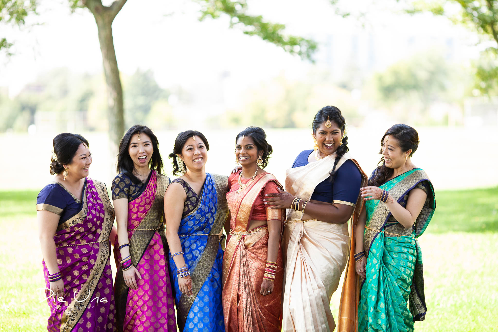 bride and bridesmaids wearing sarees and laughing outside.jpg